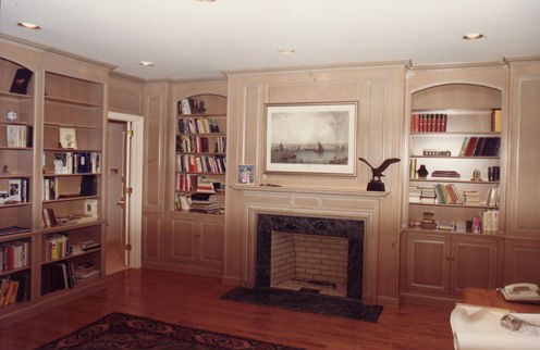 Fairbanks mantel with oval panel and matching paneled room with bookcases
